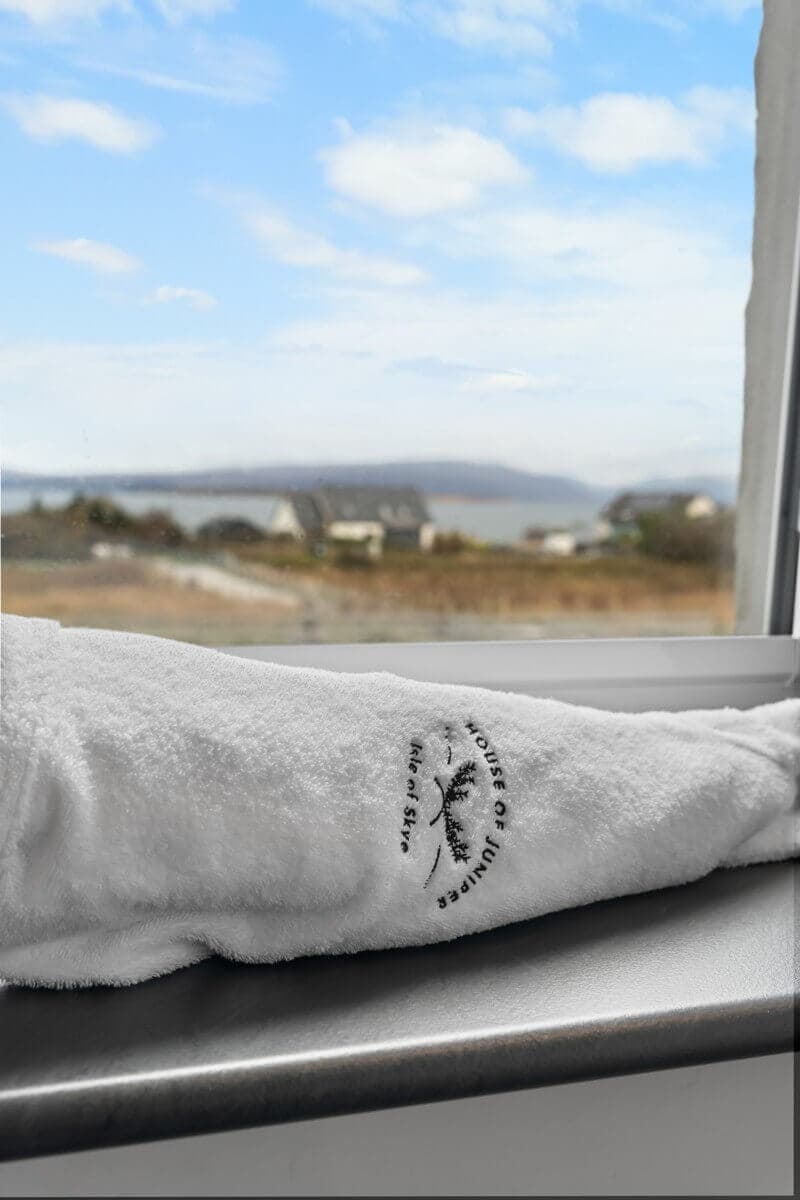 The Manse Hotel logo on a towel with sea view